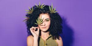 Woman holding cannabis leaf